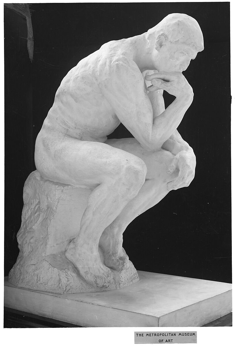 Auguste Rodin's plaster sculpture The Thinker, a seated nude male figure leaning forward with chin supported by one hand.