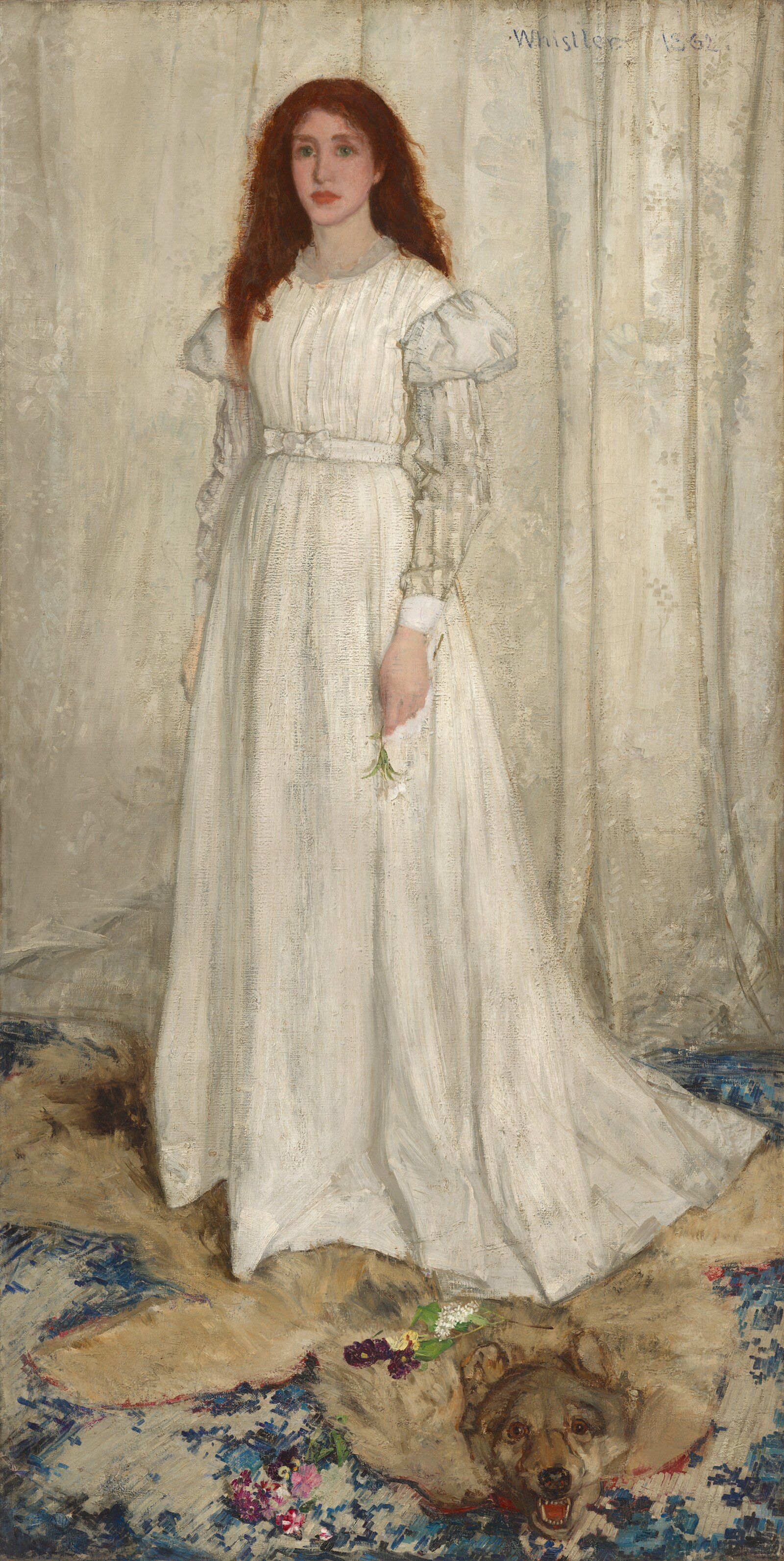 A standing woman in a long white dress appears before a pale curtain, above a dark animal pelt and patterned carpet.