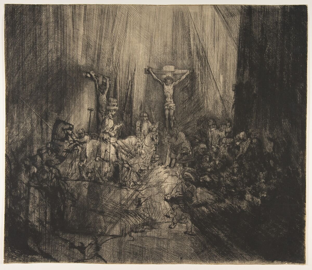 Rembrandt's drypoint The Three Crosses, with a strong light around the central cross surrounded by dense dark hatching.